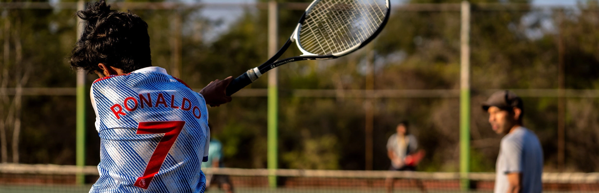  Student playing tennis.